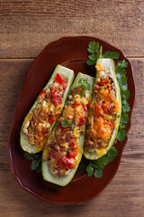 Zucchini stuffed with meat, vegetables and cheese. Zucchini boats. View from above, top studio shot