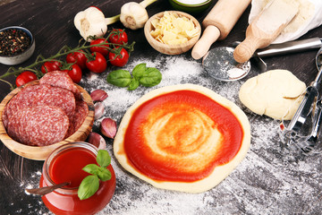Fresh original Italian raw pizza preparation with fresh ingredients
