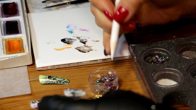 manicurist preform sticks to the nail decoration element