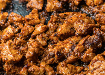 fried pork chopped slice of steak in sauce cooking meat in a frying pan