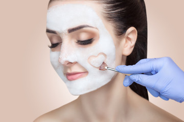 Cosmetic procedure, applying an oxygen mask on the face of a beautiful girl in beauty salon....