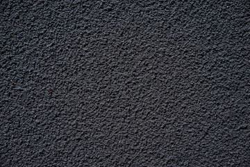 Black sand textured background.