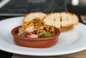 appetizing appetizer whole shrimp with nuts and garlic with chili pepper ceramic bowl