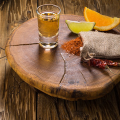 Mezcal shot mexican drink with orange and lime slices, chili pepper and worm salt in oaxaca mexico.