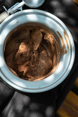 Bowl of chocolate ice cream on black  background.Top view
