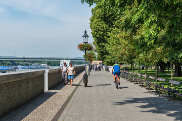 Bratislava, Slovakia - May 24, 2018: People walk and ride a bike in Bratislava along the Danube River.