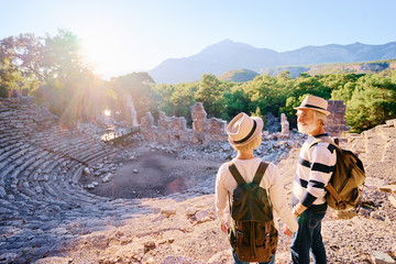 Travel and tourism. Senior family couple enjoying view together on ancient amphitheatre.