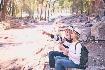 Travel and technology. Senior traveling family couple using tablet computer at ancient sightseeing.