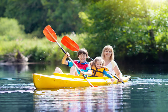 Child on kayak. Kids on canoe. Summer camping.