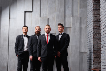 Group of handsome elegant young men in toxedo.