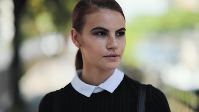 Slow motion close up of beautiful woman posing outdoors