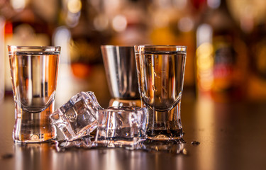 Traditional pure vodka in glasses on a black background, chilled drink