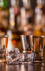 Traditional pure vodka in glasses on a black background, chilled drink