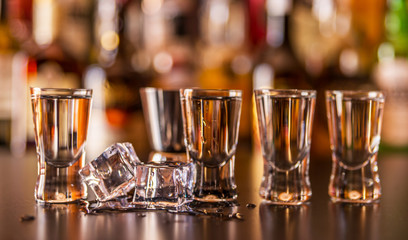 Traditional pure vodka in glasses on a black background, chilled drink