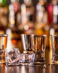 Traditional pure vodka in glasses on a black background, chilled drink