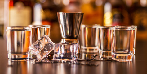 Traditional pure vodka in glasses on a black background, chilled drink