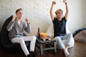 Football fans watch the match and drink beer