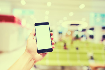 Male hand holding smartphone with copy space on the screen.