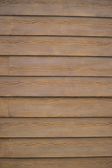 Fototapeta premium Brown Vinyl Siding Made to Look Like Wood Grain