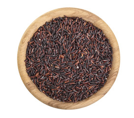 black rice grains in wooden bowl isolated on white background. Top view. Flat lay
