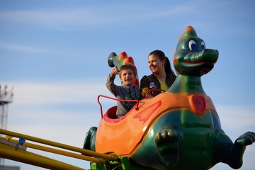 Mother and son ride on the Russian roller coaster