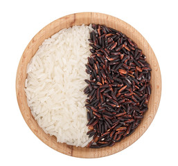 white and black rice grains in wooden bowl isolated on white background. Top view. Flat lay