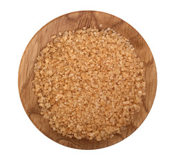 brown granulated sugar in wooden bowl isolated on white background. Top view. Flat lay