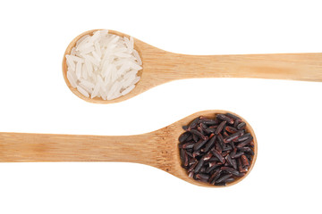 white and black rice grains in wooden spoon isolated on white background. Top view. Flat lay