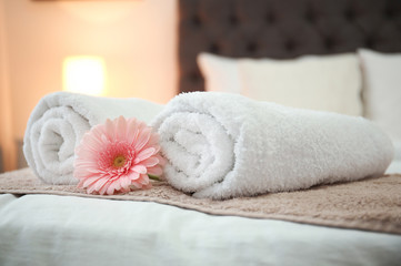 Fototapeta na wymiar Clean towels on bed in hotel room