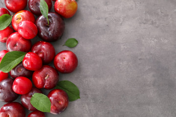 Ripe juicy plums on table