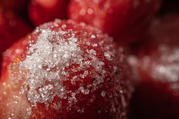 Strawberry berries sprinkled with sugar closeup