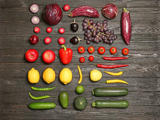 Rainbow collection of ripe fruits and vegetables on wooden background, top view