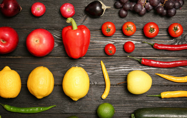 Rainbow collection of ripe fruits and vegetables on wooden background, top view