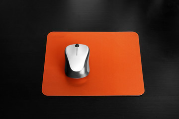 Blank pad and wireless computer mouse on black background © New Africa