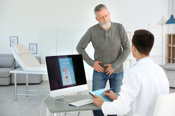 Man with health problem visiting urologist at hospital - obrazy, fototapety, plakaty
