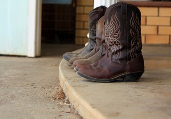 Womens leather cowboy boots removed outside after used on the farm in Tamworth, New South Wales, rural Australia