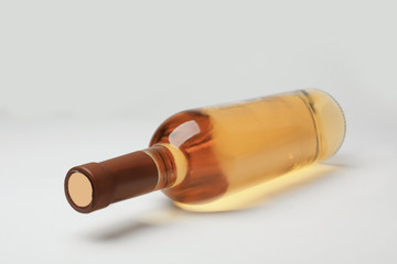 Bottle of expensive white wine on light background