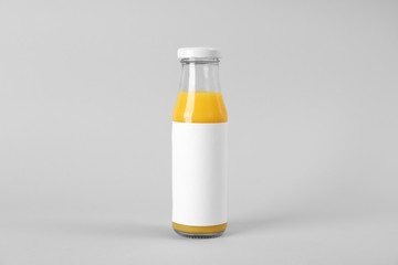 Bottle with delicious fresh juice on light background