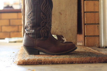 Womens leather cowboy boots removed outside after used on the farm in Tamworth, New South Wales,...