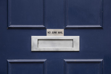 Mail slot with sign "no junk mail"