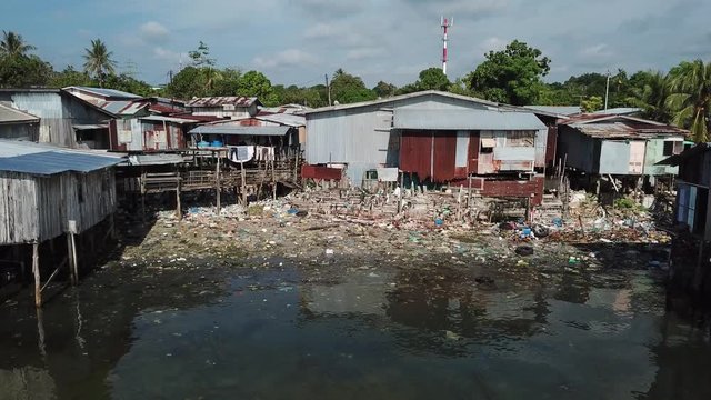 Poverty and pollution. Plastic trash dumped in poor fishing village 