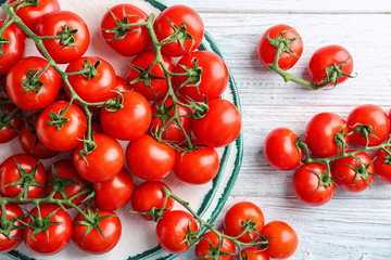 Flat lay composition with ripe tomatoes on wooden background