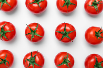 Flat lay composition with ripe tomatoes on light background