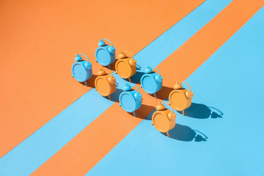 Colorful clocks on vibrant background.