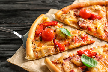 Delicious pizza with tomatoes and sausages on table