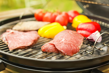 Modern grill with meat and vegetables outdoors, closeup