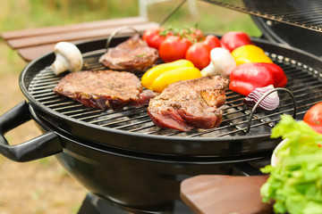 Modern grill with meat and vegetables outdoors, closeup