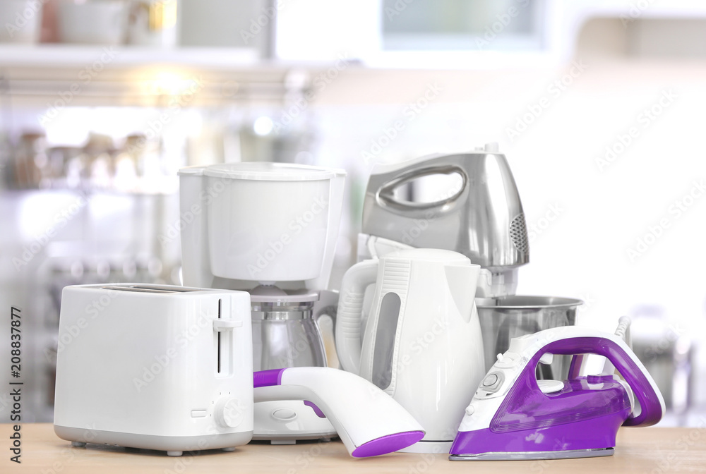 Poster household and kitchen appliances on table indoors. interior element