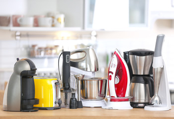 Household and kitchen appliances on table indoors. Interior element