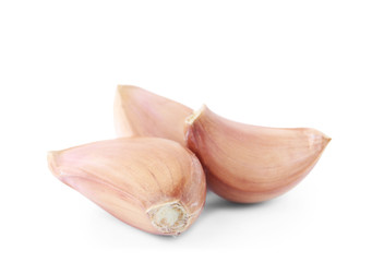 Fresh unpeeled garlic cloves on white background